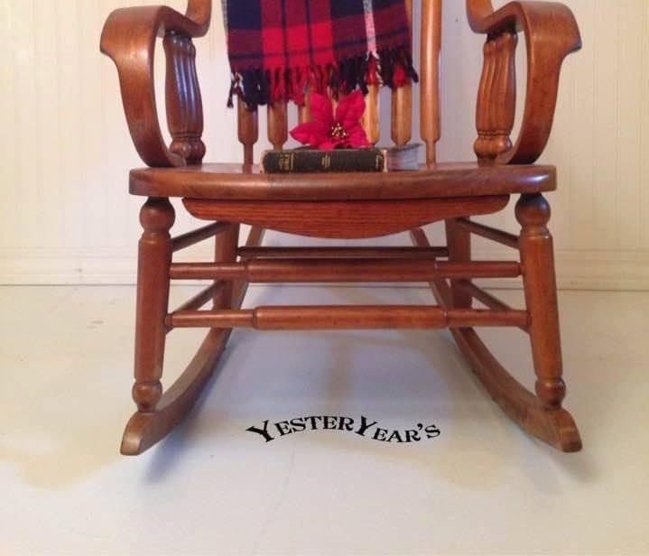 Wooden rocking chair with a plaid blanket